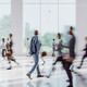 Business people walking through office building