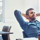 An employee leans back at his desk