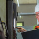 Worker checking a machine in a warehouse