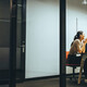 A group of employees gather in a meeting room