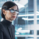 woman looks at computer monitor in office
