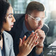 IT team looks at charts on monitor