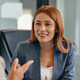 Three professionals in a discussion at an office meeting