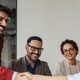 Colleagues shaking hands in an office business meeting