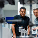 Coworkers discussing manufacturing