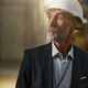 Man in hardhat looking in warehouse