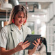 Businesswoman using tablet in modern office