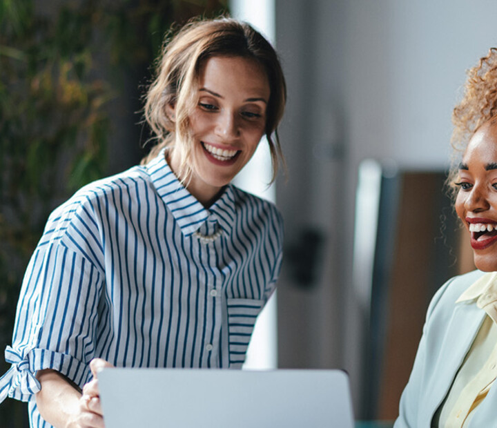 Two businesswomen viewing a laptop 