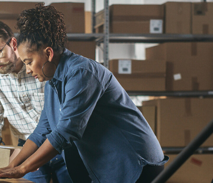 Two business owners in a warehouse