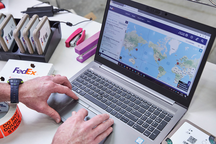 A FedEx employee using data analytics and maps. 