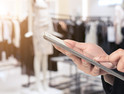 A user with a smartphone in a retail store. 