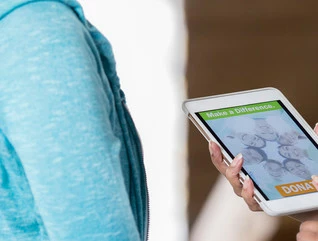 Nonprofit worker takes a mobile donation on a tablet