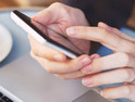 close up of hands using mobile application on smartphone, woman checking emails on her smart phone in cafe