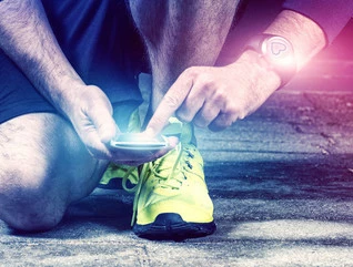 Runner uses mobile phone and smart watch with pulse tracking