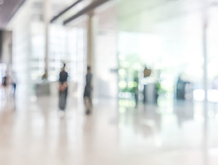 bank building lobby blur background interior view toward reception hall, modern luxury white room space with blurry corridor and building glass wall window
