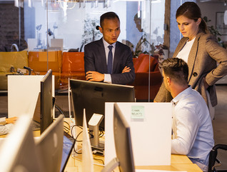 Business people at computers meeting