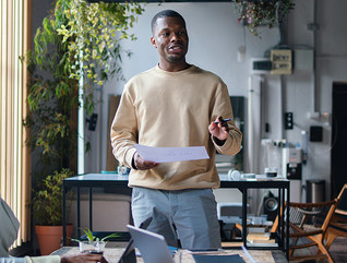 Man talking to 2 people from notes