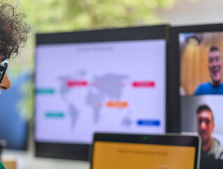 Businessperson with colleagues during conference call