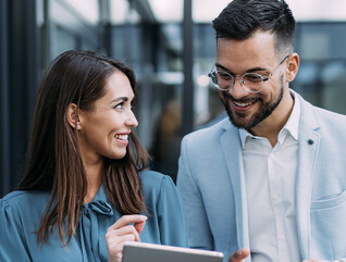 Business people using digital tablet outdoors