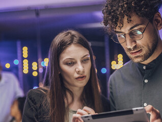 Coworkers reviewing tablet