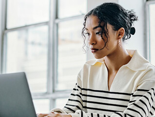 Person using laptop in the office