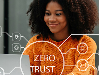 Person using computer and tablet with zero trust icon