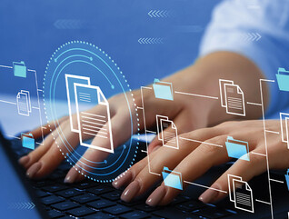 woman's hands typing on laptop