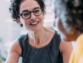 Two females talking in an office