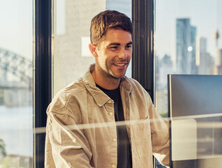 IT leader working on a large monitor display