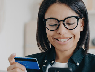 Person paying with card and a phone