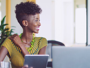 small business owners smile around computer