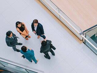 Business leaders gathered in a hallway