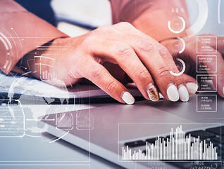 Business women typing on laptop.