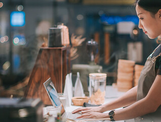 lady at counter on laptop