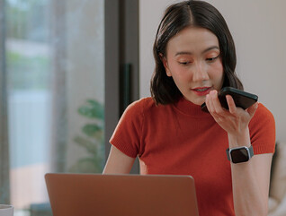 Person using phone and computer