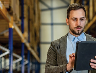 man on tablet in warehouse