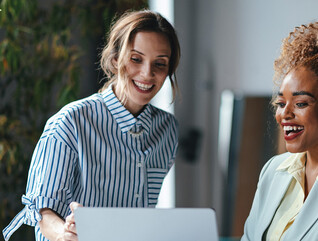 Two businesswomen viewing a laptop 