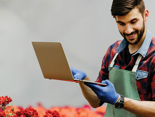 botanist uses laptop in the field