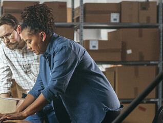Two business owners in a warehouse