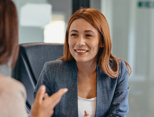 Three professionals in a discussion at an office meeting
