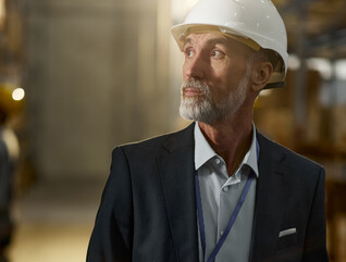 Man in hardhat looking in warehouse
