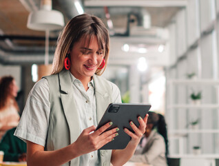 Businesswoman using tablet in modern office