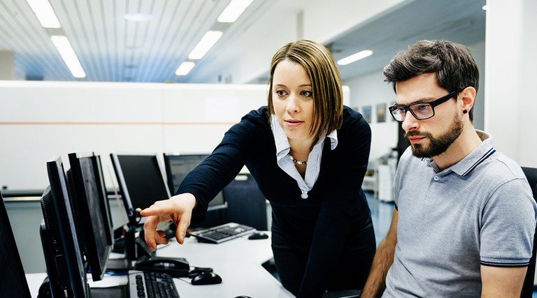 Two IT pros working on cybersecurity 