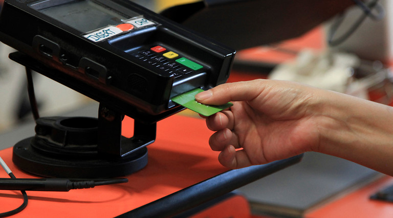 Woman using a smart card to make a purchase 