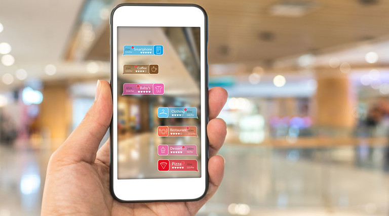 Augmented reality marketing in the shopping mall. Hand holding smart phone use AR application to check information