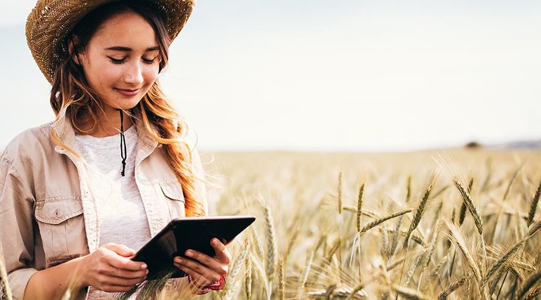 Girl in field with iPad