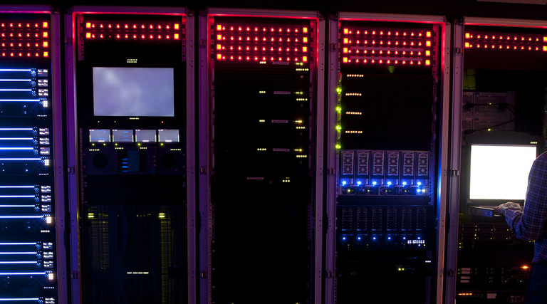 Modern interior of server room in datacenter. IT Engineer in Action Configuring Servers