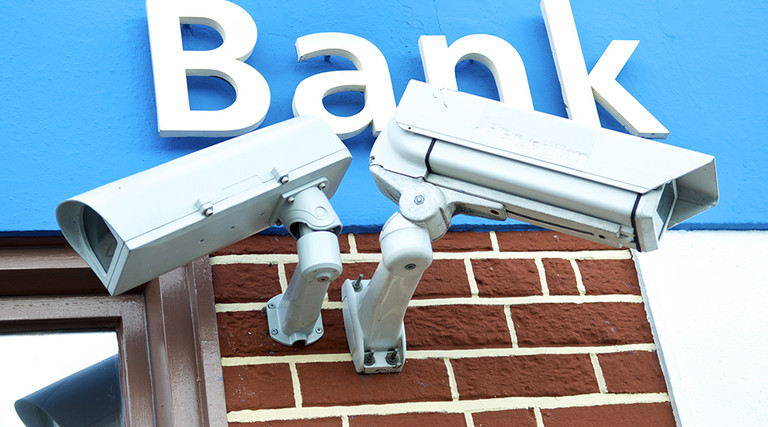 A bank protects its customers with two IP-enabled surveillance cameras
