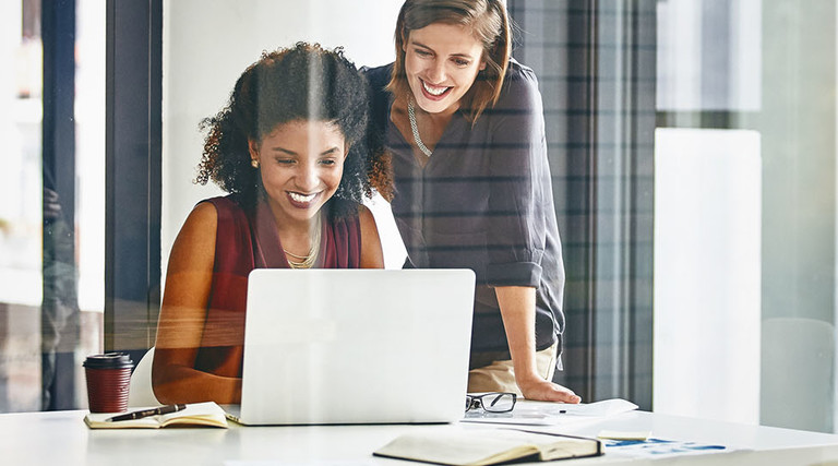  Cropped shot of two businesswomen working together on a laptop in an office