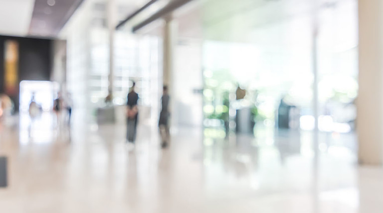 bank building lobby blur background interior view toward reception hall, modern luxury white room space with blurry corridor and building glass wall window